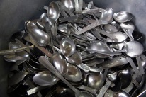 A large pile of newly washed cutlery in the Gudwara's kitchen. They await today's guests and worshipers.