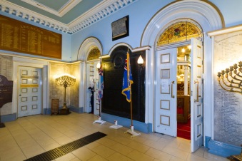 The entrance hall to Singers Hill synagogue in central Birmingham. Note the war memorial to those from the community who died in World War I alongside traditional Jewish religious artifacts like the Menorah.